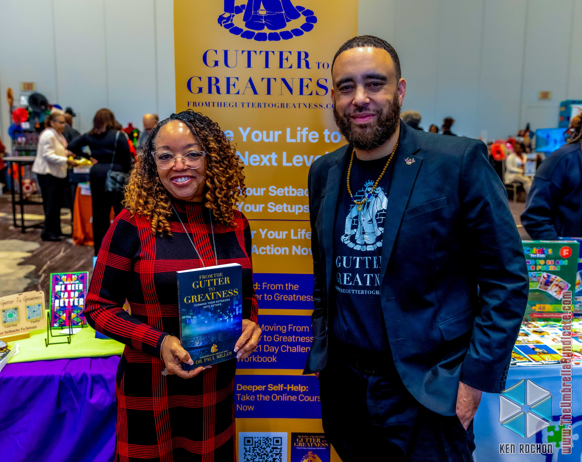 Dr. Miller meeting a reader at the Gutter to Greatness display